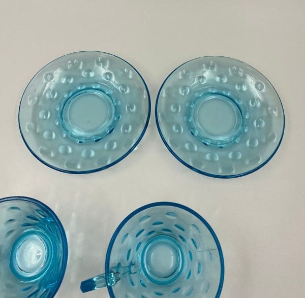 blue glass tea cups and saucers