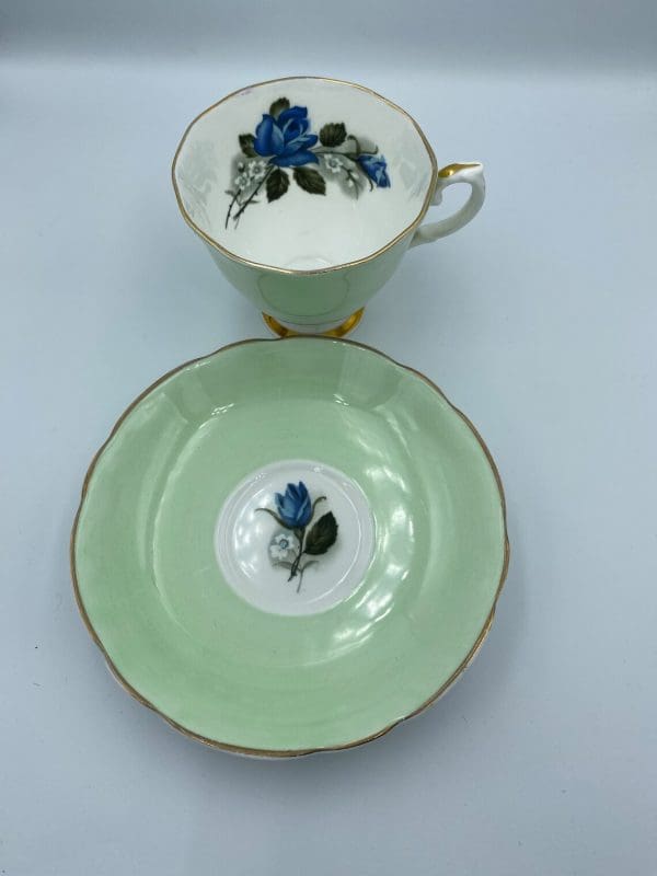 Consort teacup light green with Blue Rose inside blue flower on saucer