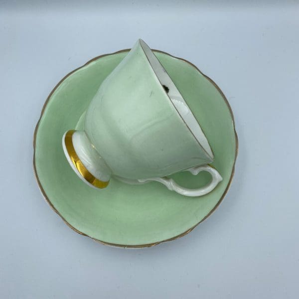 Consort teacup light green with Blue Rose inside right side