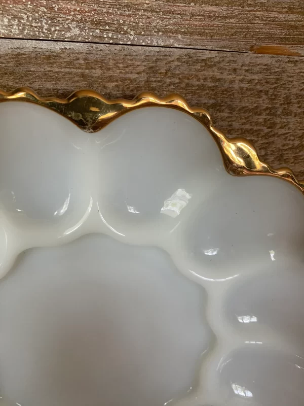 vintage deviled egg dish close to edge to show gold on white milk glass