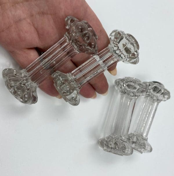 vintage glass knife rests in hand to show size