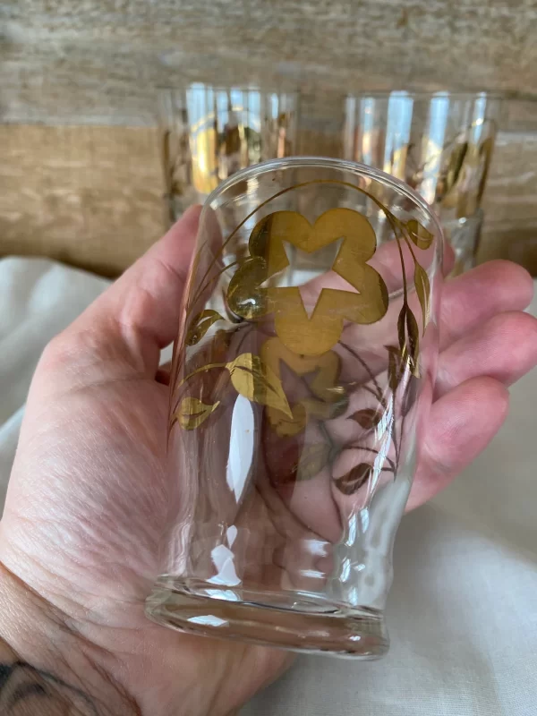 vintage juice glasses gold flower design in hand to show size