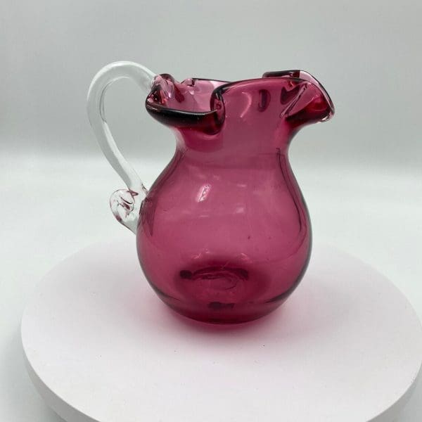 vintage pink glass pitcher with applied clear glass handle