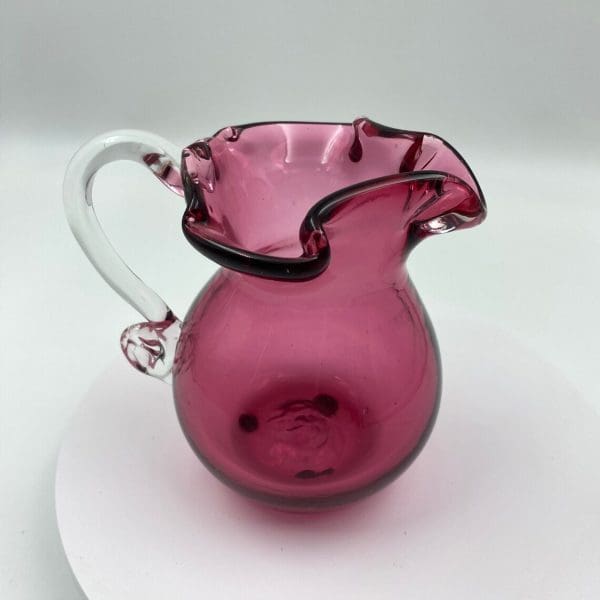 vintage pink glass pitcher edge of top