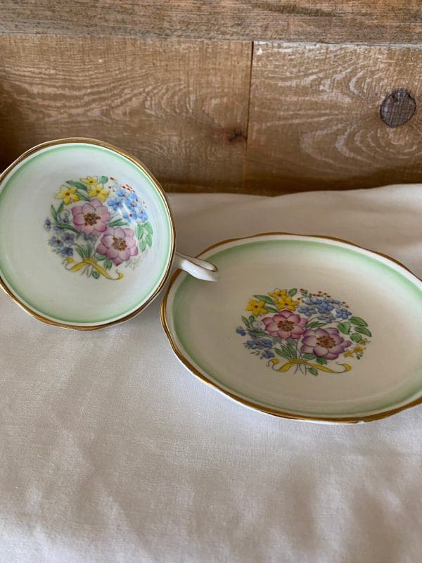 Royal Albert teacup and saucer green white with flowers side by side